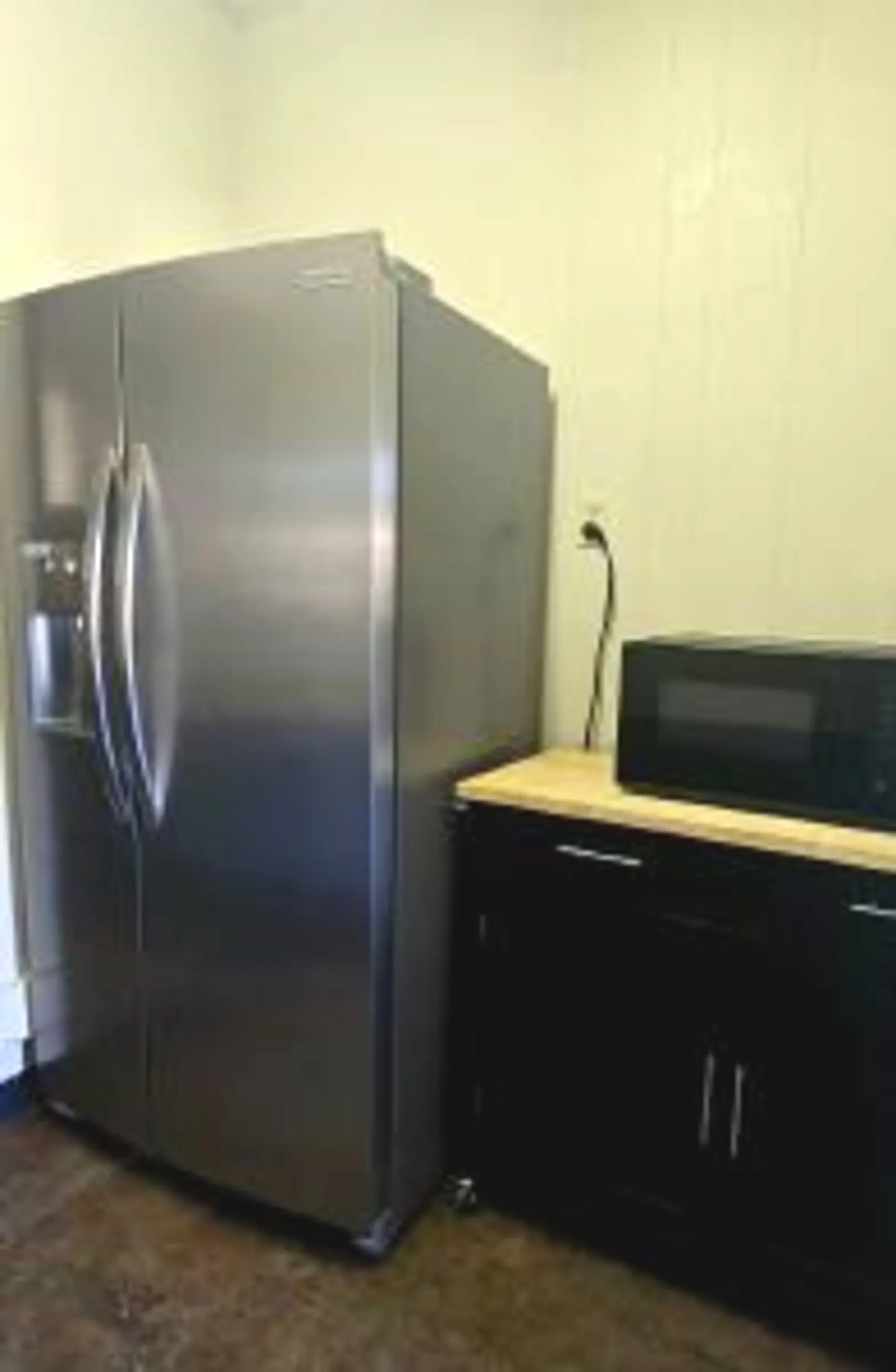 Full-size refrigerator stocked with drinks and catering items.